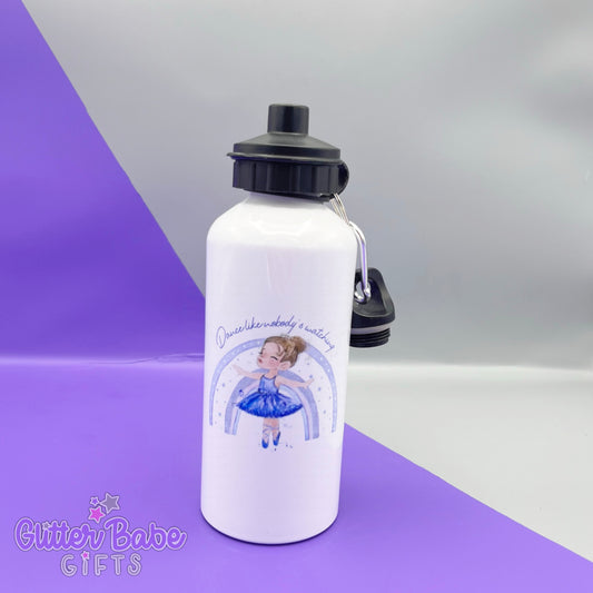 white bottle with two black lids that has a ballerina image with blonde hair printed on it the ballerina stands in front of a lilac rainbow with text reading "dance like nobody is watching". The bottle is on a purple and grey background.