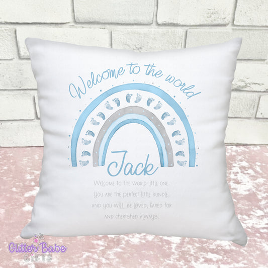 White Cushion with Blue baby feet themed rainbow and writing