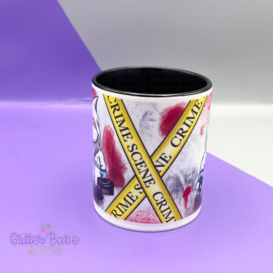 White mug with black handle and inner with edge of a gnome showing and the Crime Scene Tape to show middle view of design