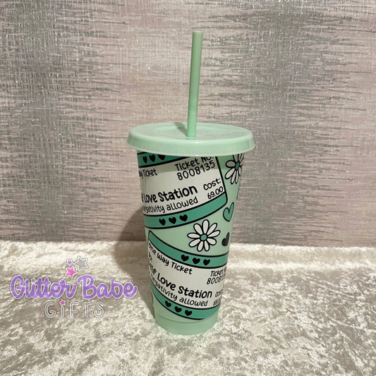 A mint green cold cup with a travel ticket style pattern and the text 'Self Love Station' printed on it.