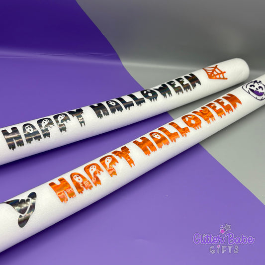 Two Halloween-themed sticks with 'Happy Halloween' text on a purple and gray background, featuring the brand 'Glitter Babe Gifts'.