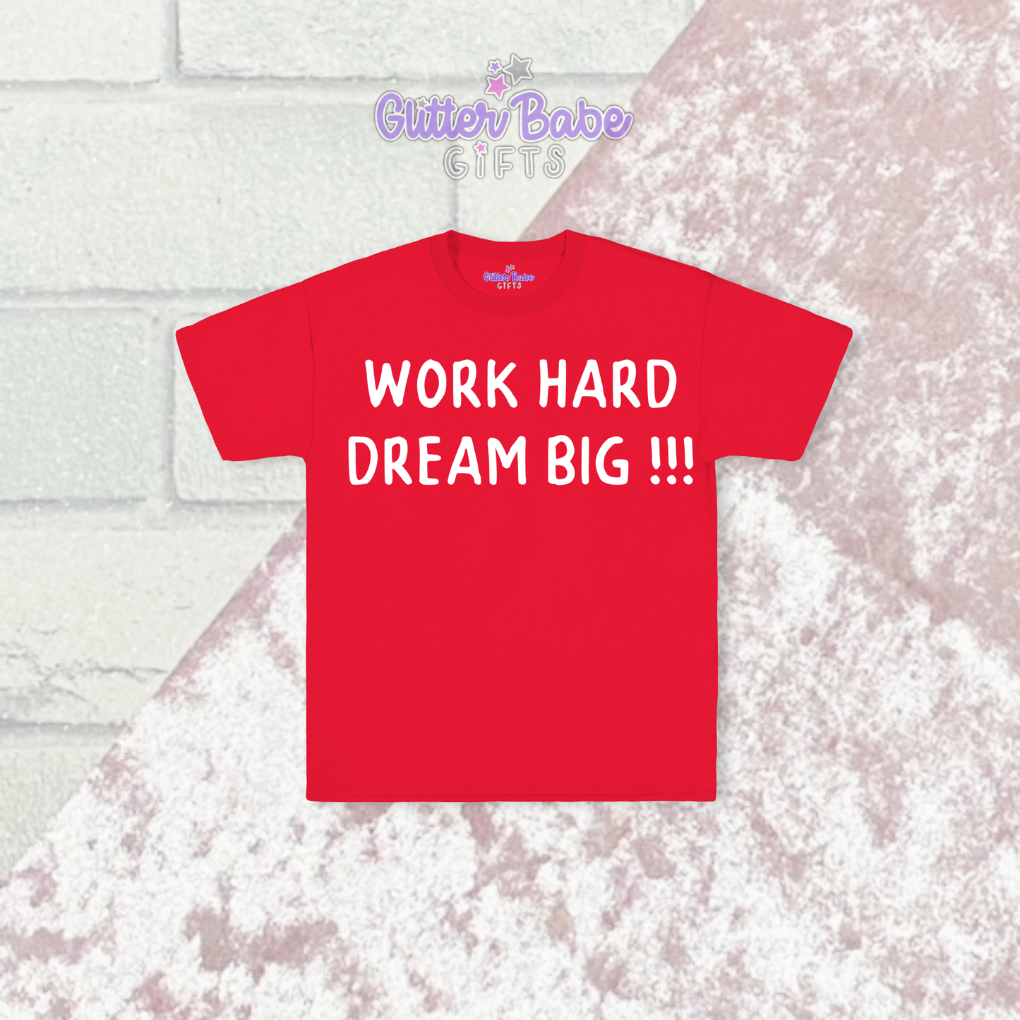 Red t-shirt with white writing on a pink and brick background