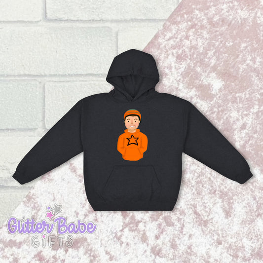 A Dark Heather hoodie with a graphic of a cartoon character on the front centre positioned above a pocket. The hoodie is displayed against a brick wall backdrop.