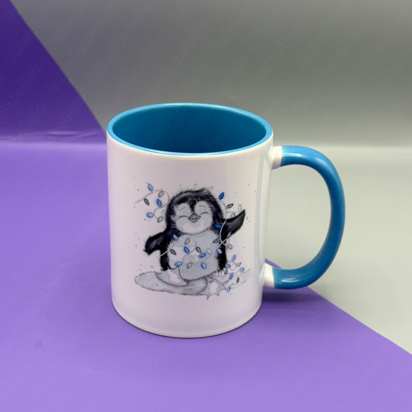 Blue and White mug with a penguin design on a purple and gray background