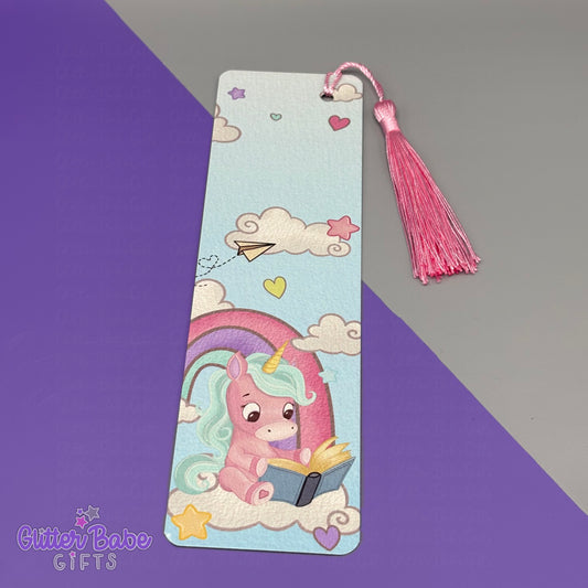 Unicorn-themed bookmark with tassel on a gradient purple and gray background, branded 'Glitter Babe Gifts'.