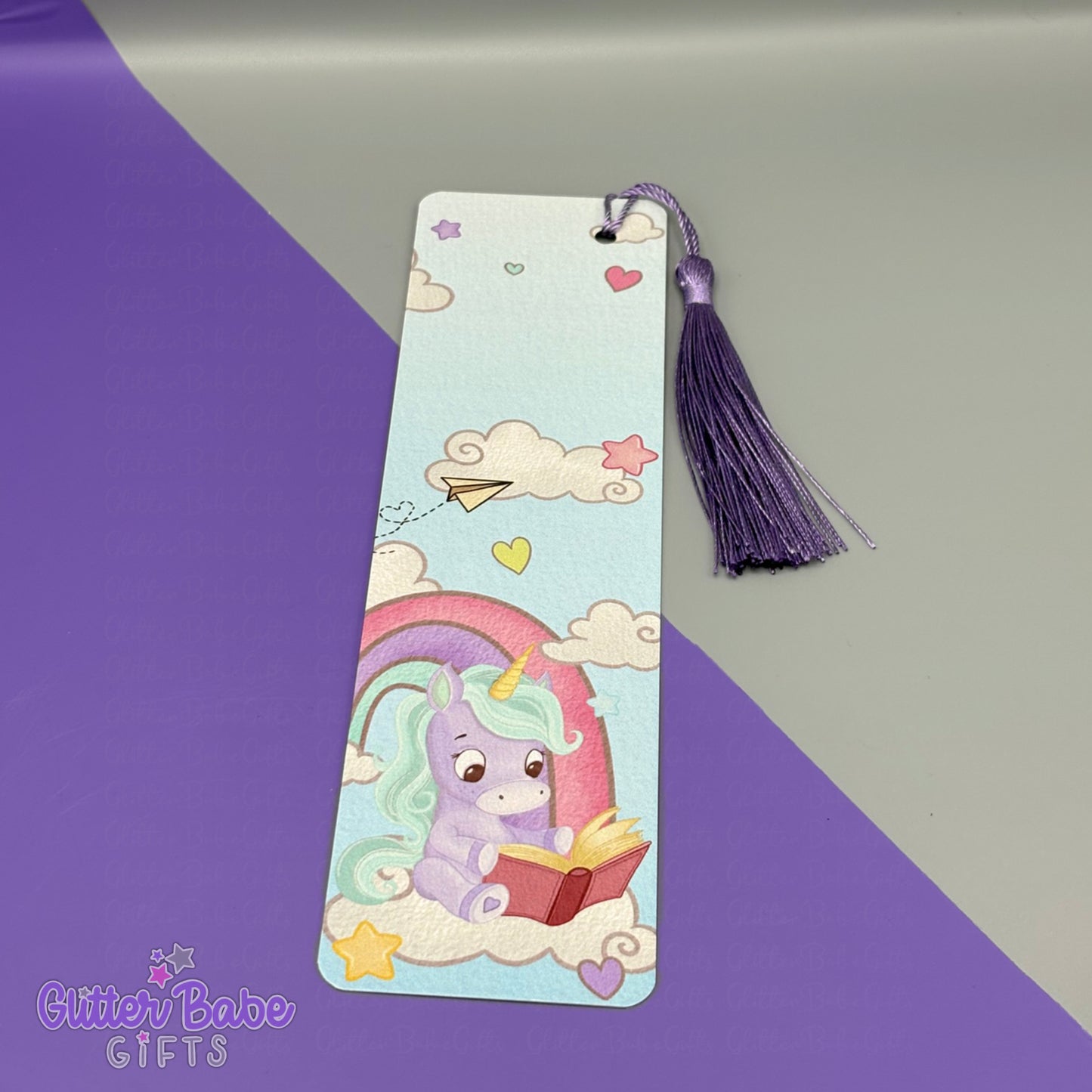 Colourful bookmark with a purple and blue unicorn design on a purple and grey background, featuring the brand 'Glitter Babe Gifts'.