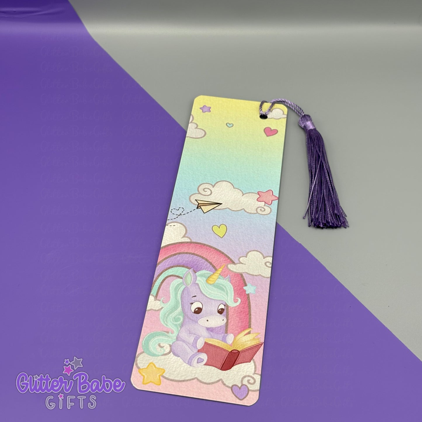 Purple and Blue Unicorn design bookmark with tassel on a gradient purple and grey background, branded 'Glitter Babe Gifts'.