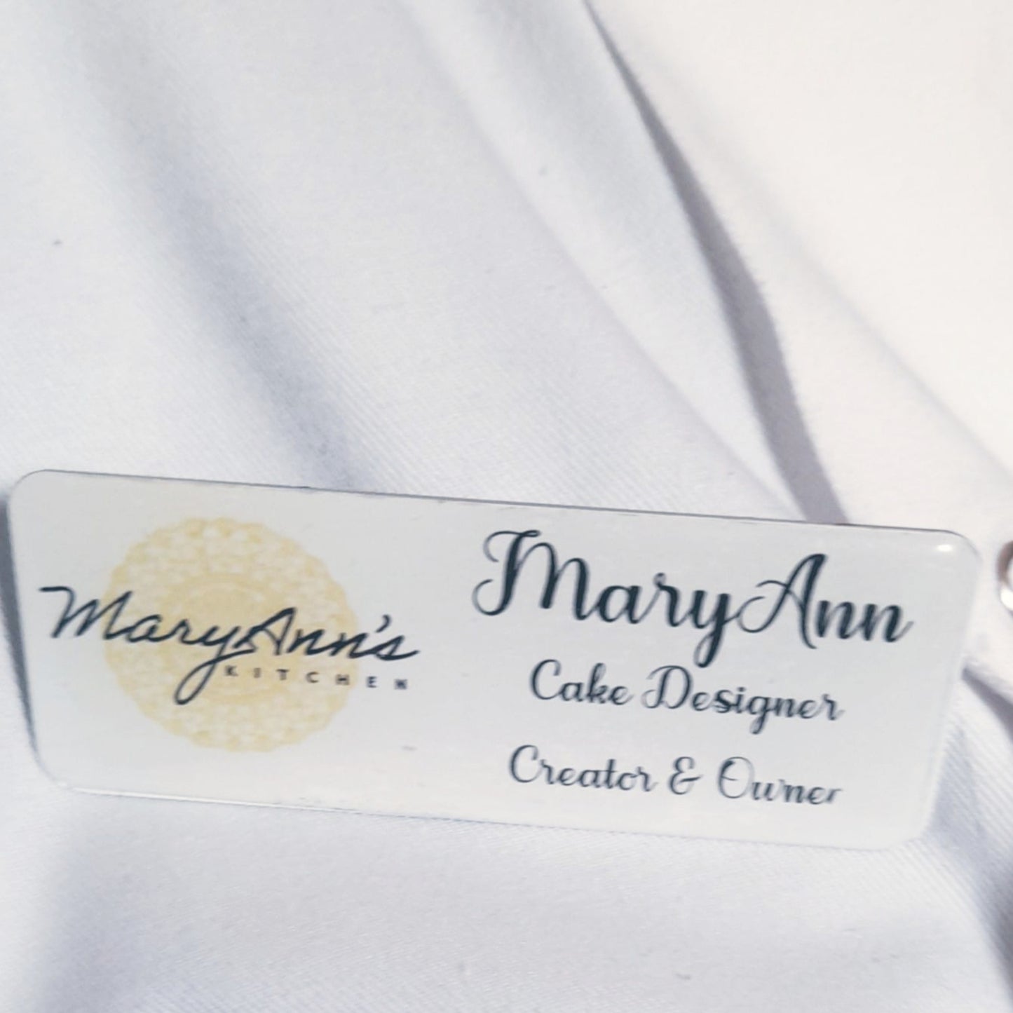 Image of a rectangular ID Badge with logo and writing on