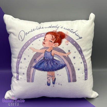 A cushion with an illustration of a ballerina with red hair in a Lilac outfit and the quote 'Dance like nobody's watching'.