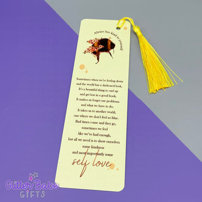 Bookmark with yellow tassel on a purple and gray background