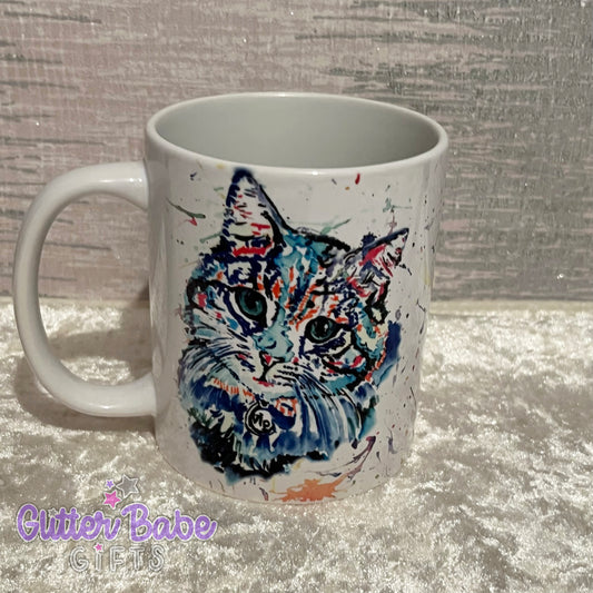 a white mug featuring a blue cat in a watercolour splash style 