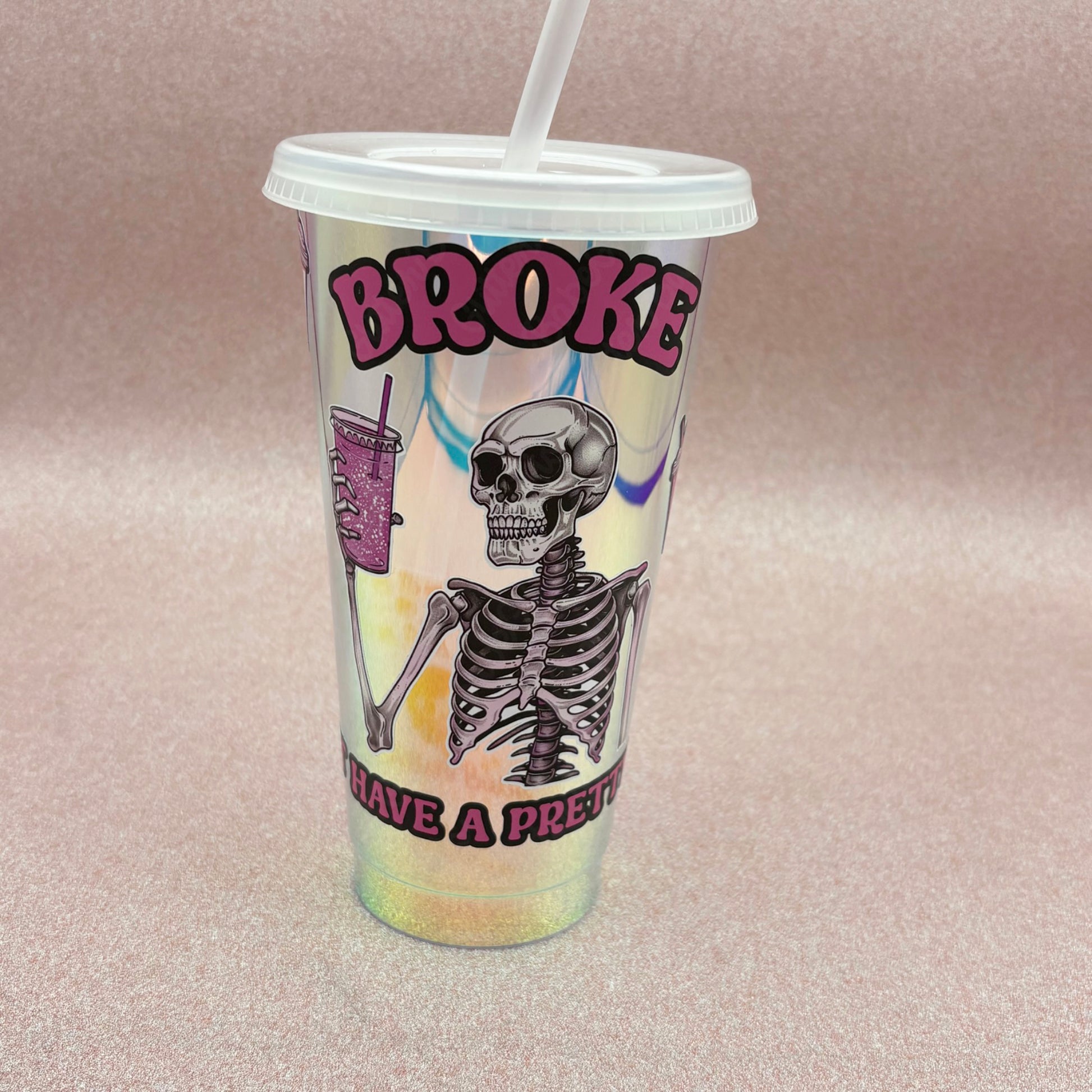 Tumbler with skeleton design and text on a pink background
