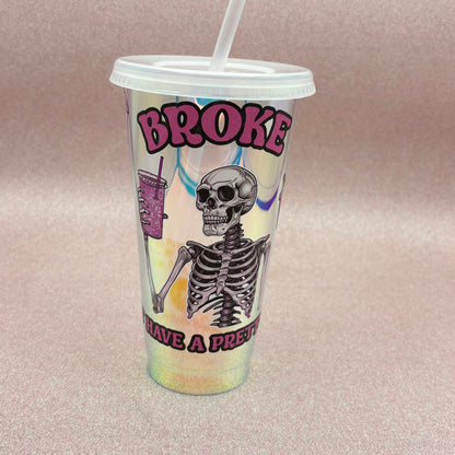 Tumbler with skeleton design and text on a pink background