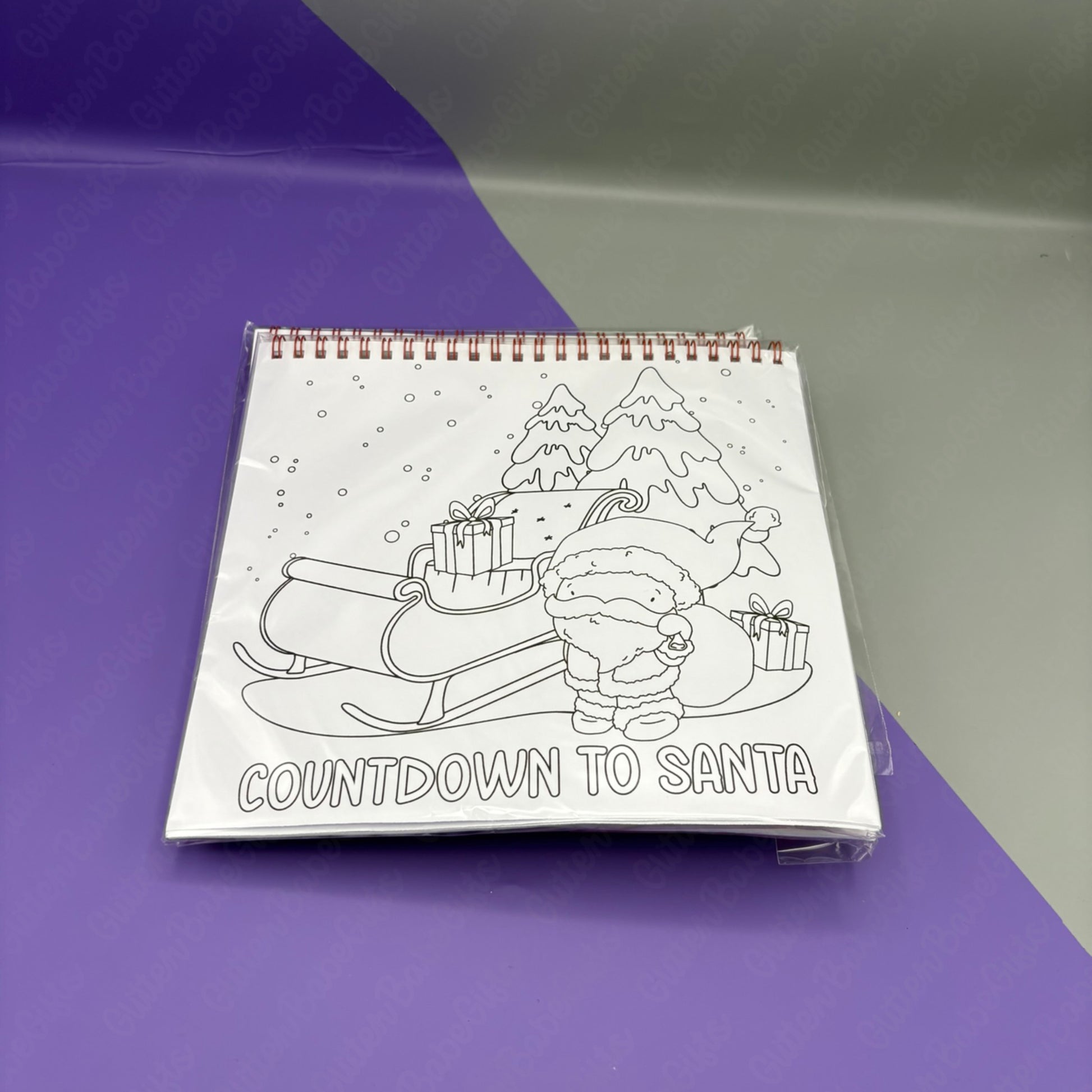 Colouring book titled 'Countdown to Santa' on a purple and gray gradient background