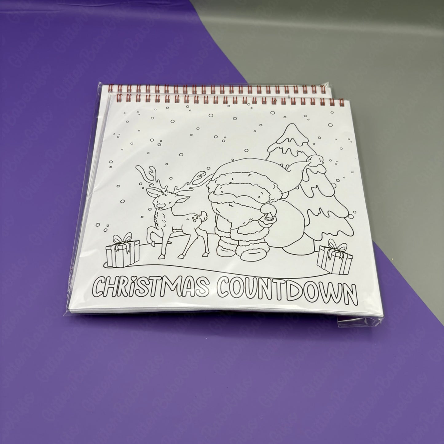 Colouring book with Christmas-themed design and 'Christmas Countdown' text on a purple surface.