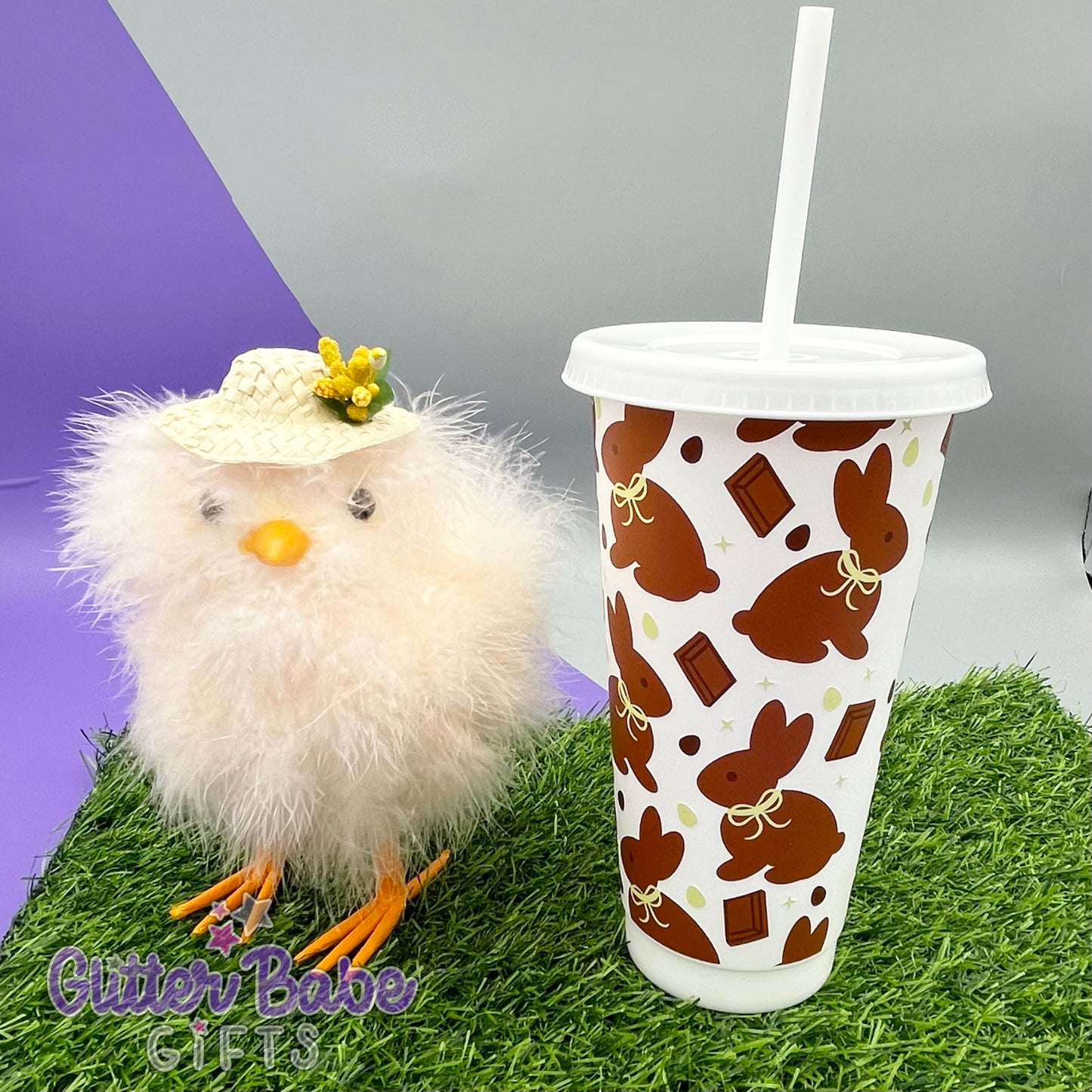 chocolate and yellow coloured easter themed wrap on white cup displayed next to an easter chick