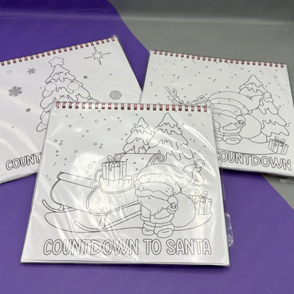 Colouring books with Christmas-themed illustrations on a purple surface