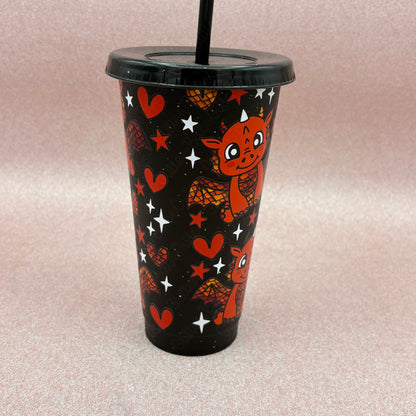 Black Glitter tumbler with red scaley dragon design on a pale pink background