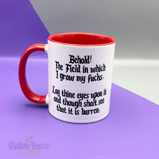 White mug with red handle and inner against a purple and grey backdrop. Mug has black text on it.