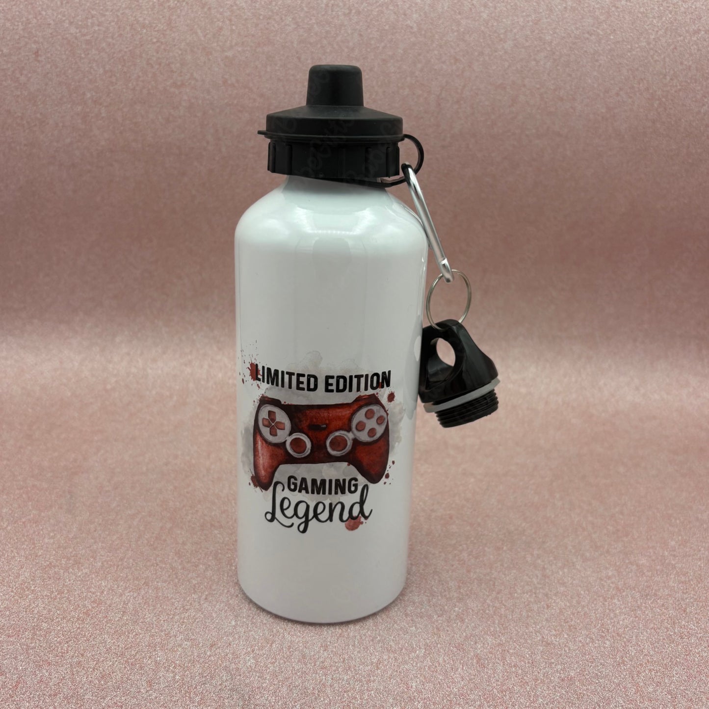 White water bottle with red gaming-themed design and black cap on a pink background