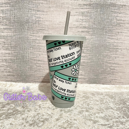 A grey cold cup with a travel ticket style pattern and the text 'Self Love Station' printed on it.
