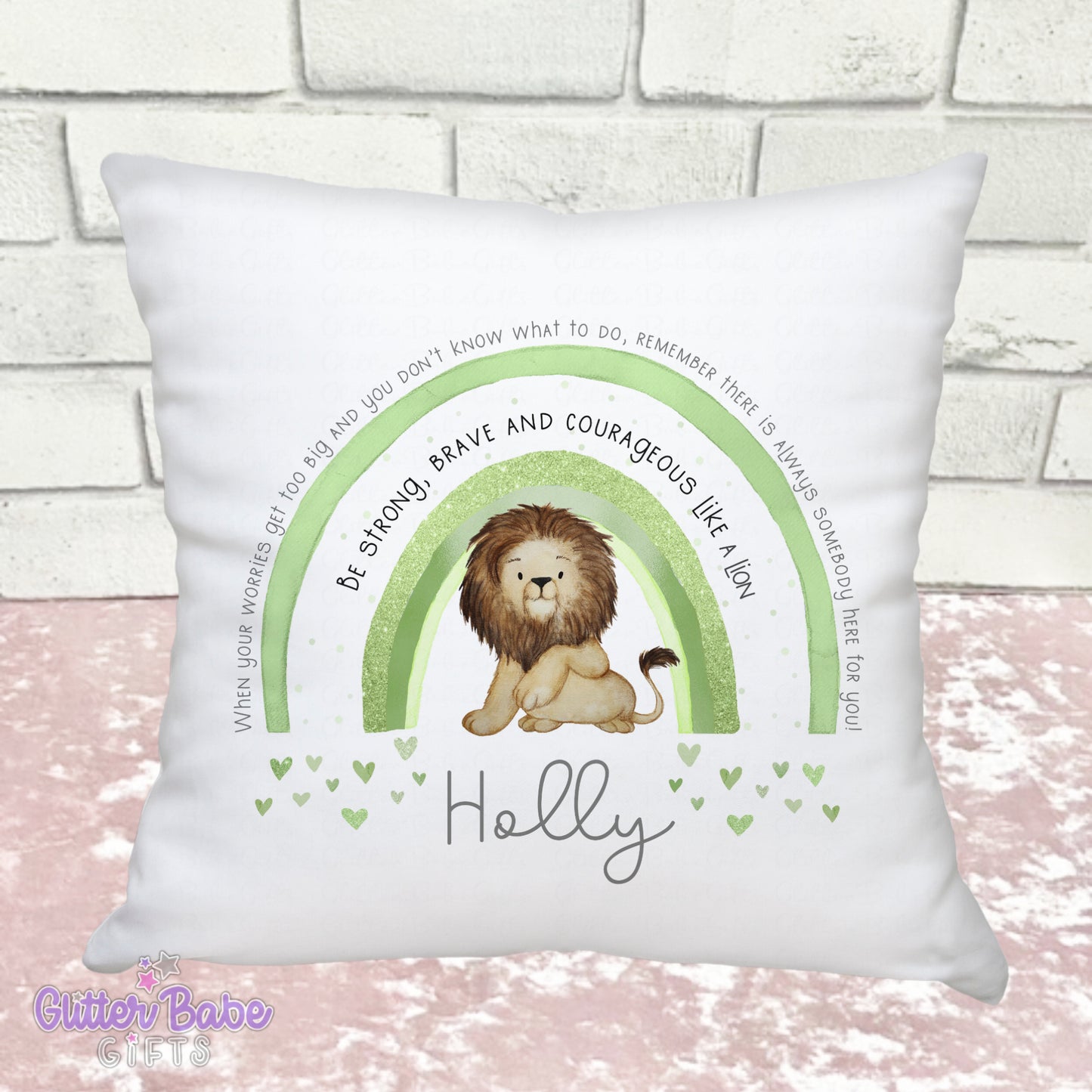 a green rainbow and a lion on a white cushion which is on a pink and white backdrop