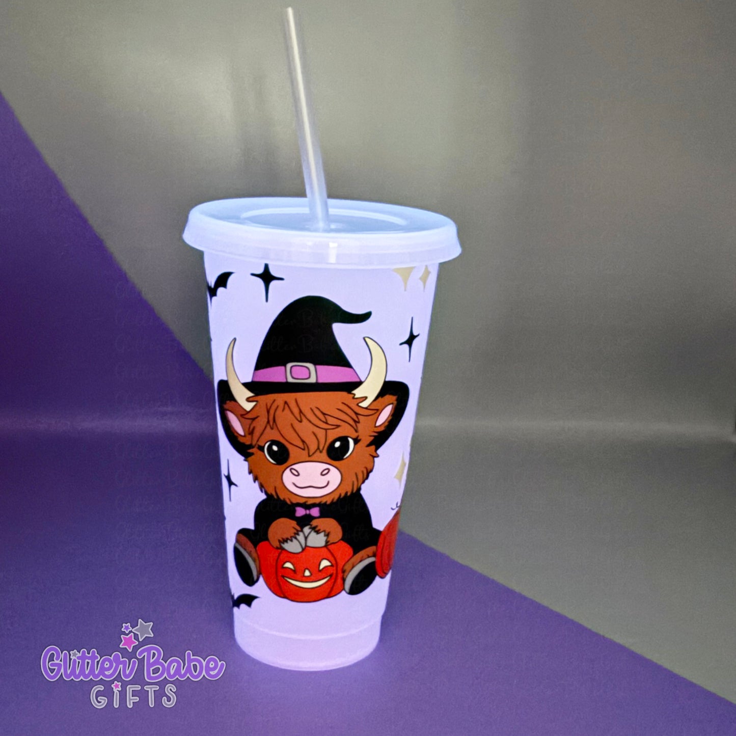 Tumbler with a cow wearing a witch hat and pumpkin design on a purple and gray background, featuring the brand 'Glitter Babe Gifts'.