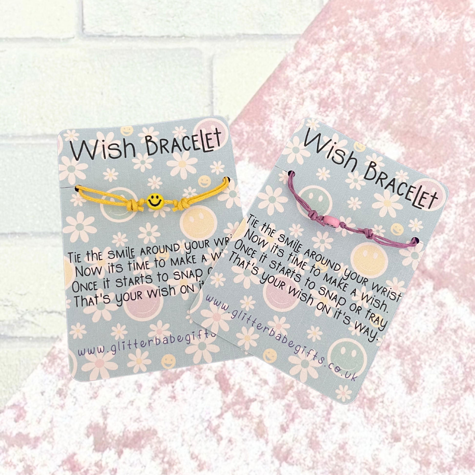 Two cord bracelets with happy face beads on floral and happy face patterned backing cards with poem on