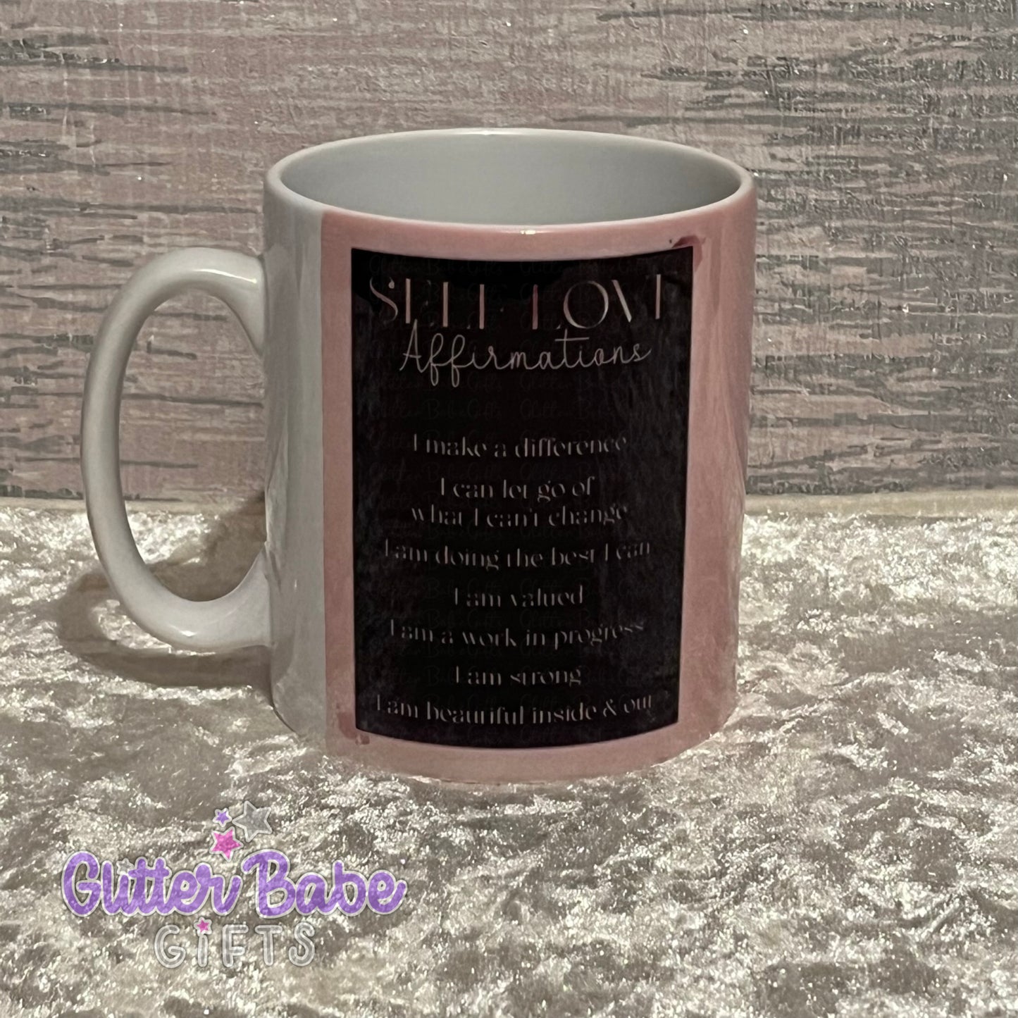 A white mug with rose gold and black colour design with self love affirmations written on it