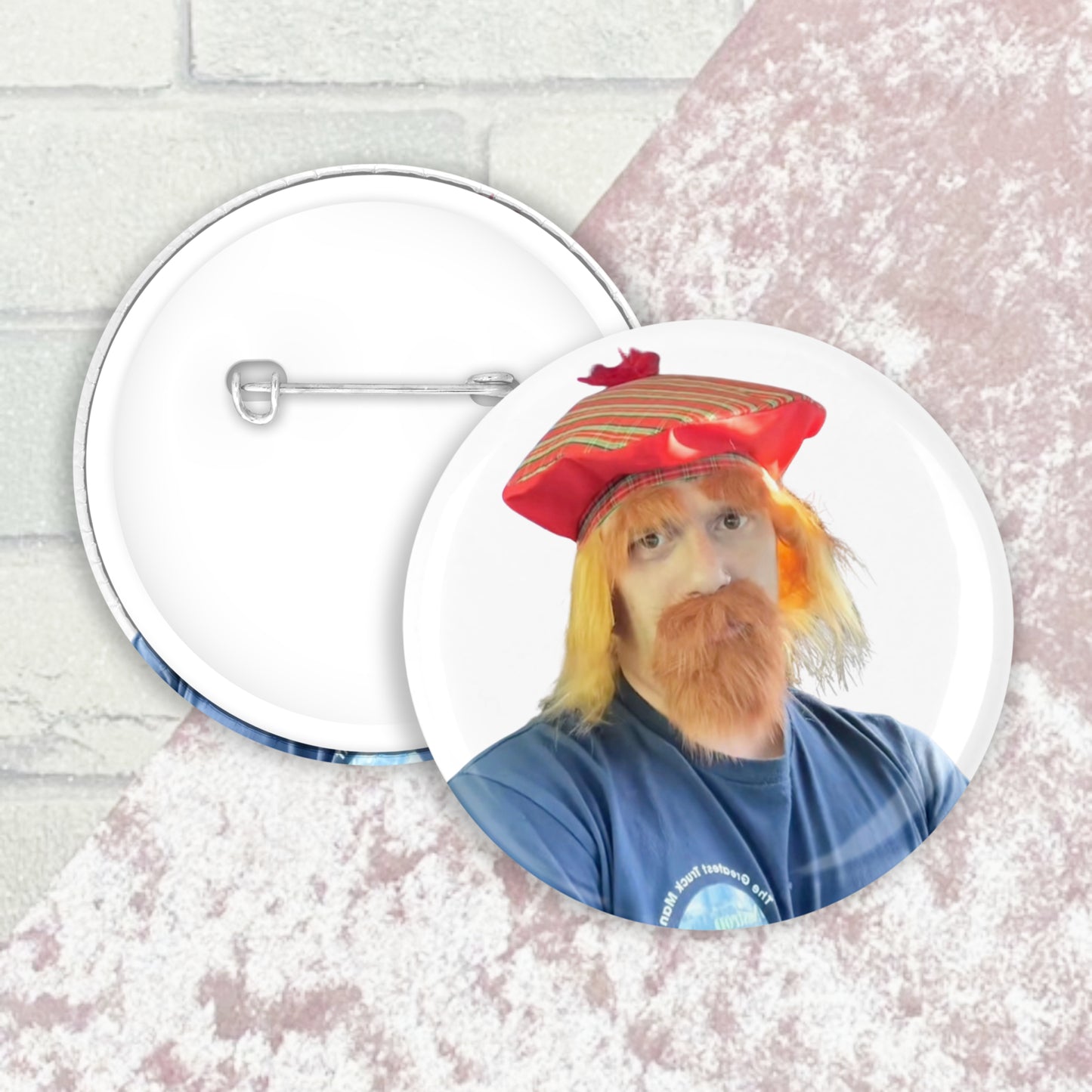 Image shows a button badge front and back image with an image of Jason Truckboy dressed in a ginger tam O'Shanter cap and beard on the front face of badge