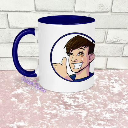 a white mug with dark blue handle and inside with image on against a white and pink background