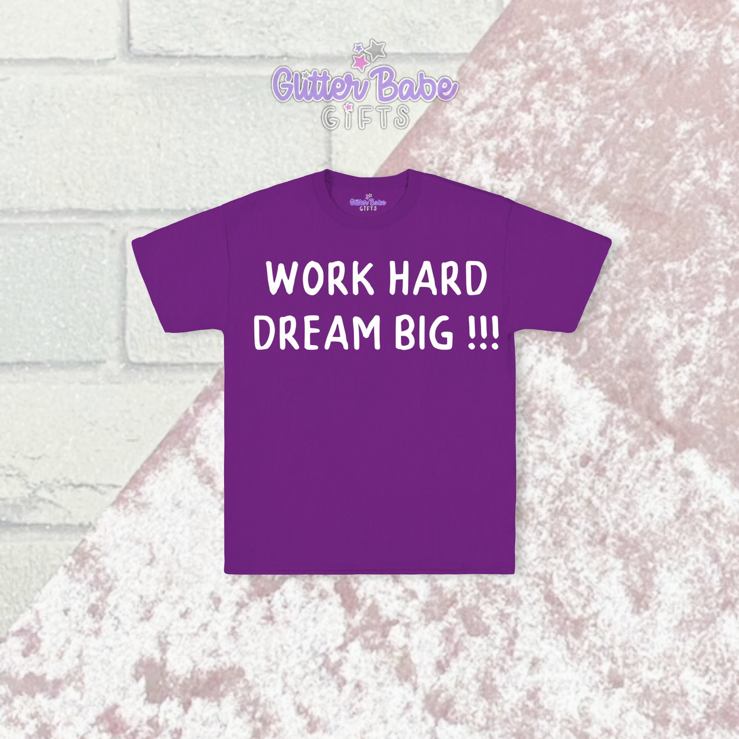 Purple t-shirt with white writing on  a pink and brick background 