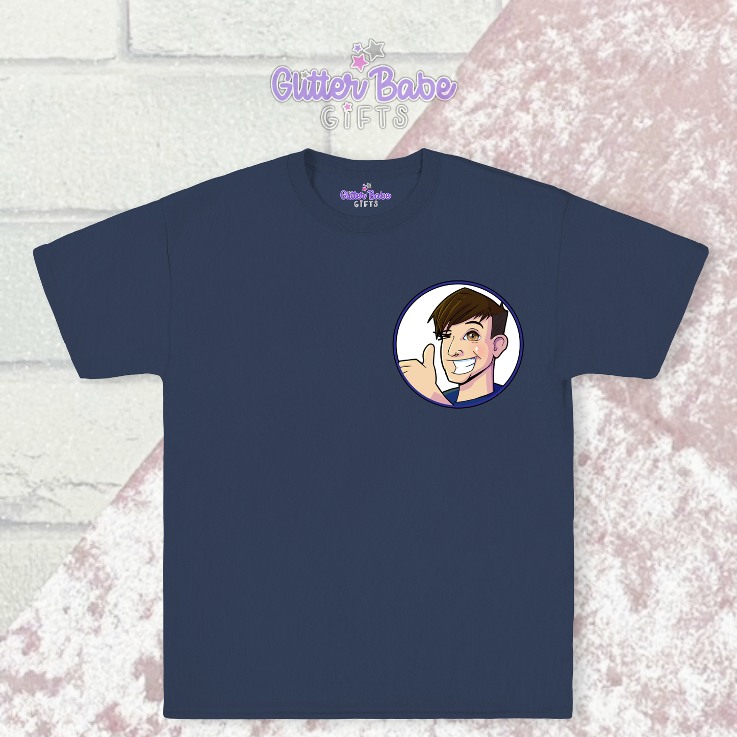 Navy t-shirt with cartoon logo on left chest laying on pink and white background