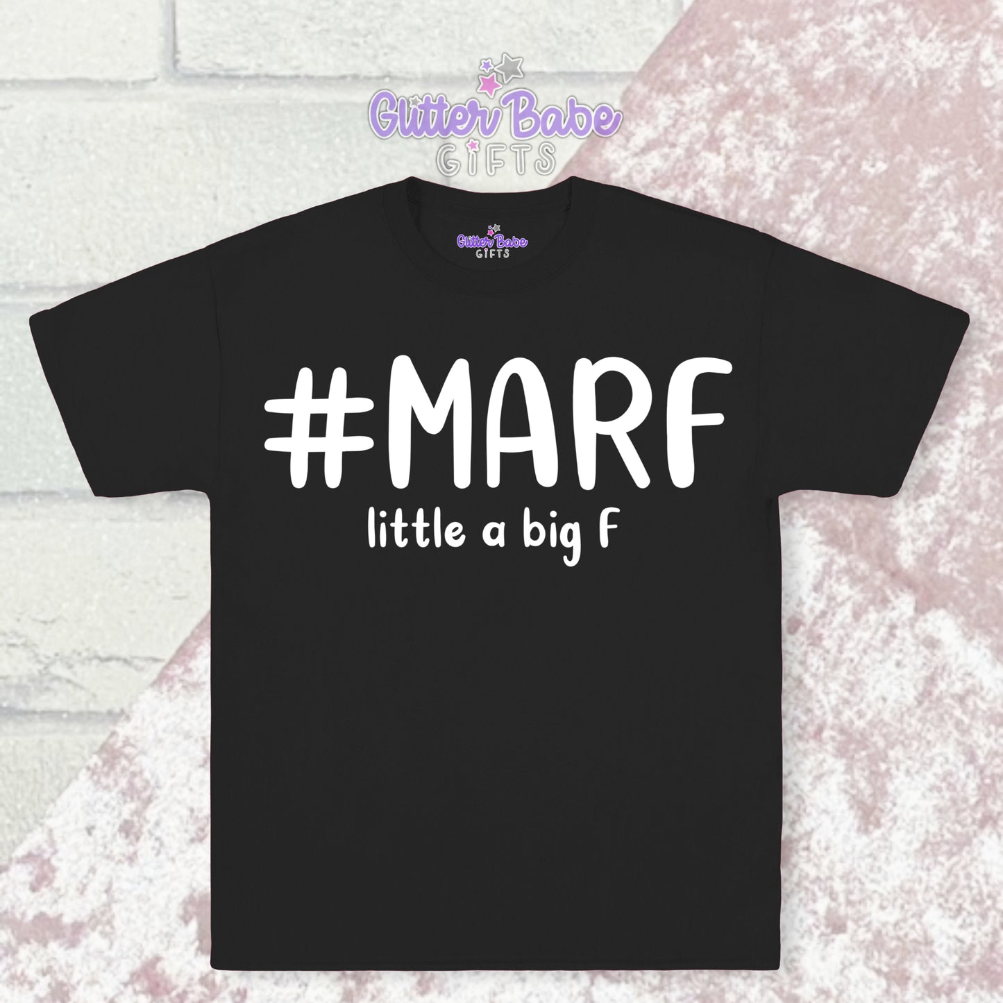  Black T-shirt with white writing saying #marf  little a big f with a pink and white backdrop