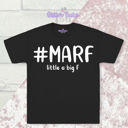  Black T-shirt with white writing saying #marf  little a big f with a pink and white backdrop