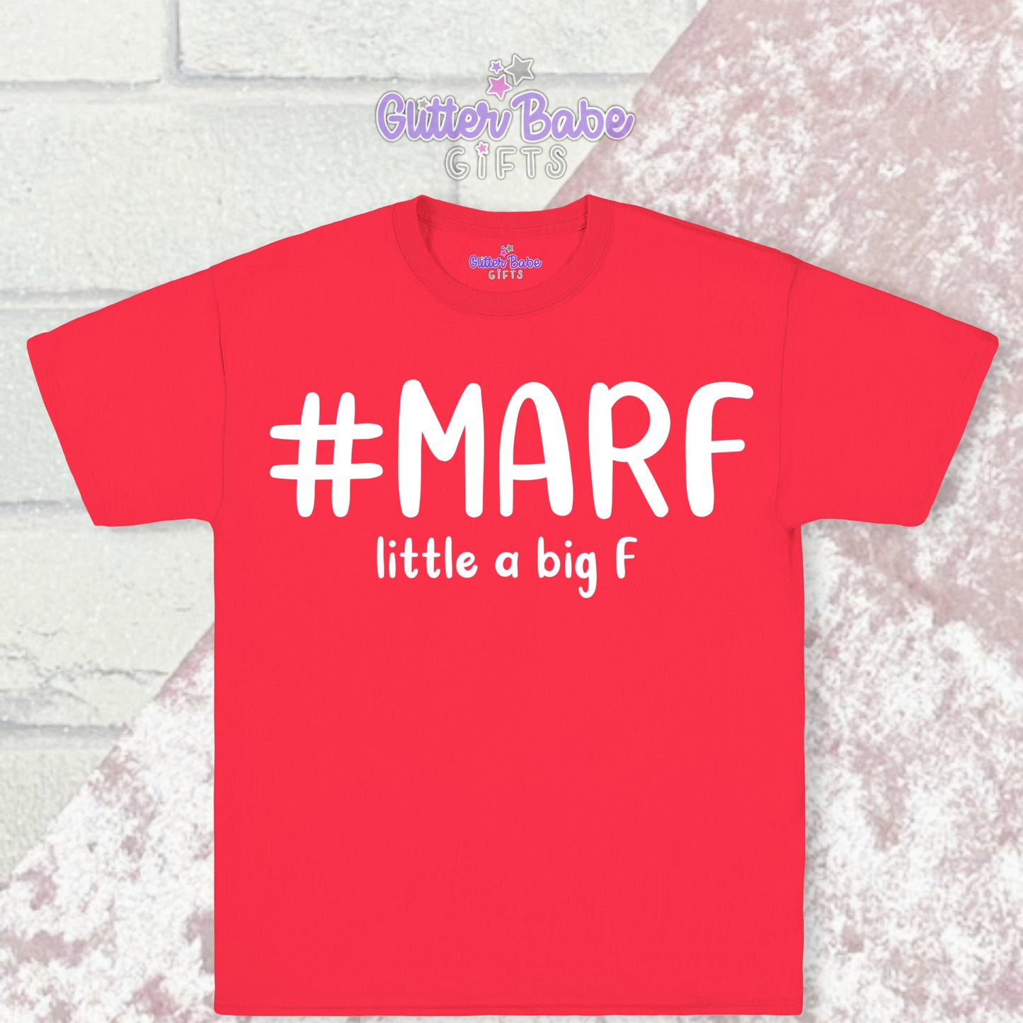 Red T-shirt with white writing saying #marf little a big f with a pale pink and white backdrop