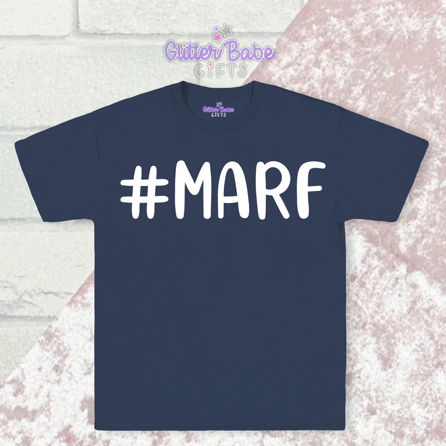 Navy Blue T-shirt with white writing saying #marf little a big f with a pale pink and white backdrop