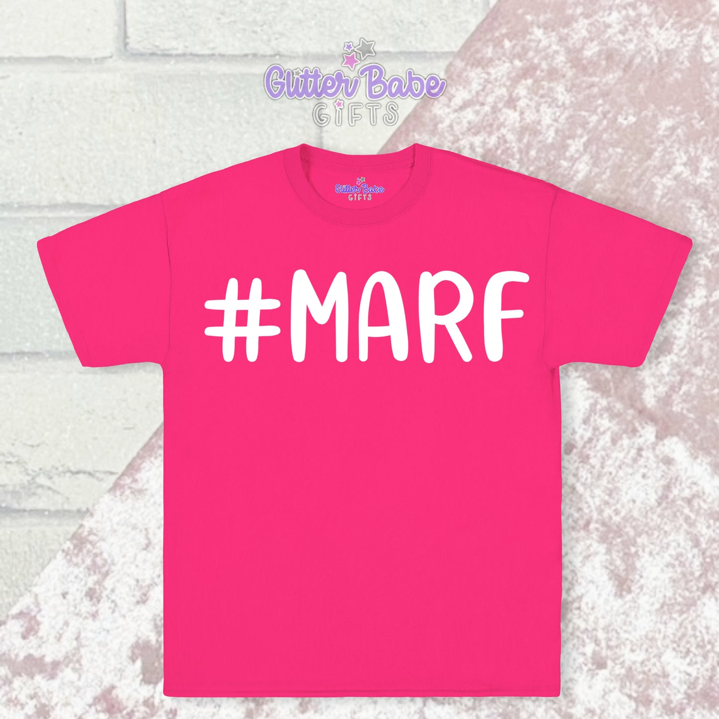  Pink T-shirt with white writing saying #marf with a pale pink and white backdrop