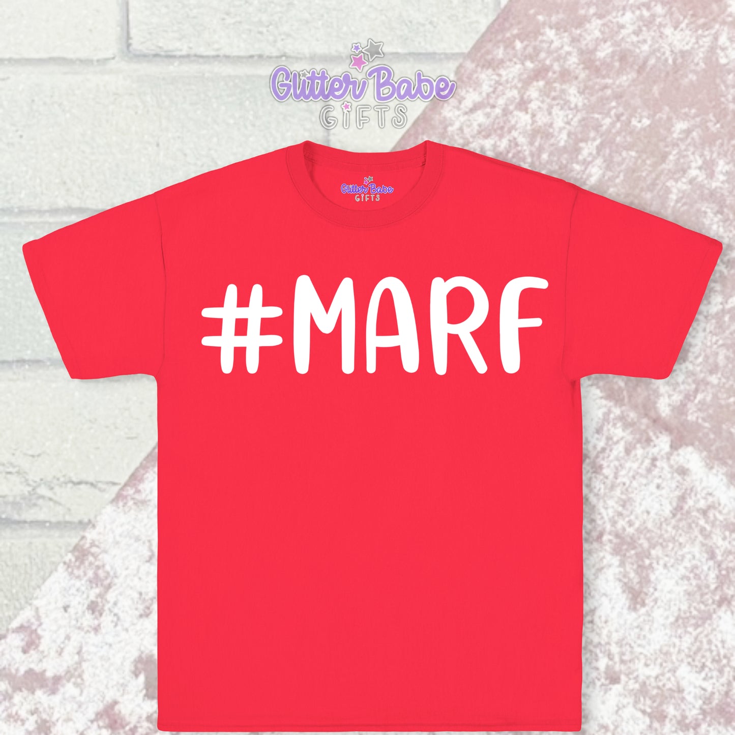 Red T-shirt with white writing saying #marf little a big f with a pale pink and white backdrop