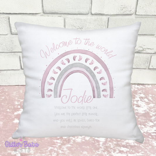 White Cushion  with pink baby feet themed rainbow  and writing