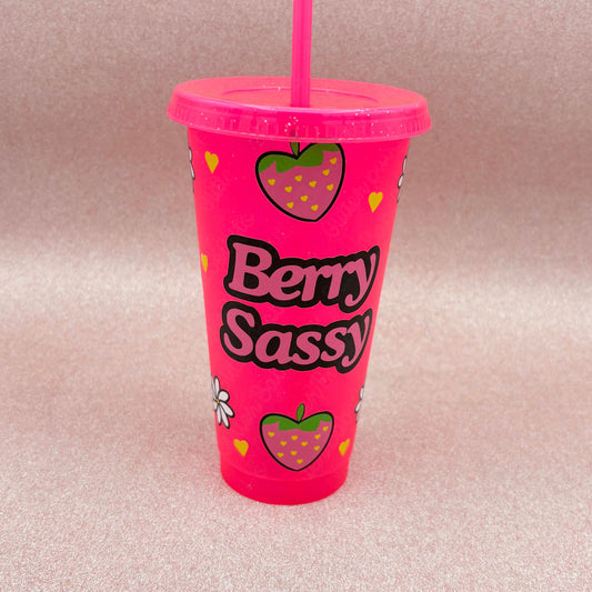 Pink tumbler with 'Berry Sassy' text and strawberry design on a light pink background