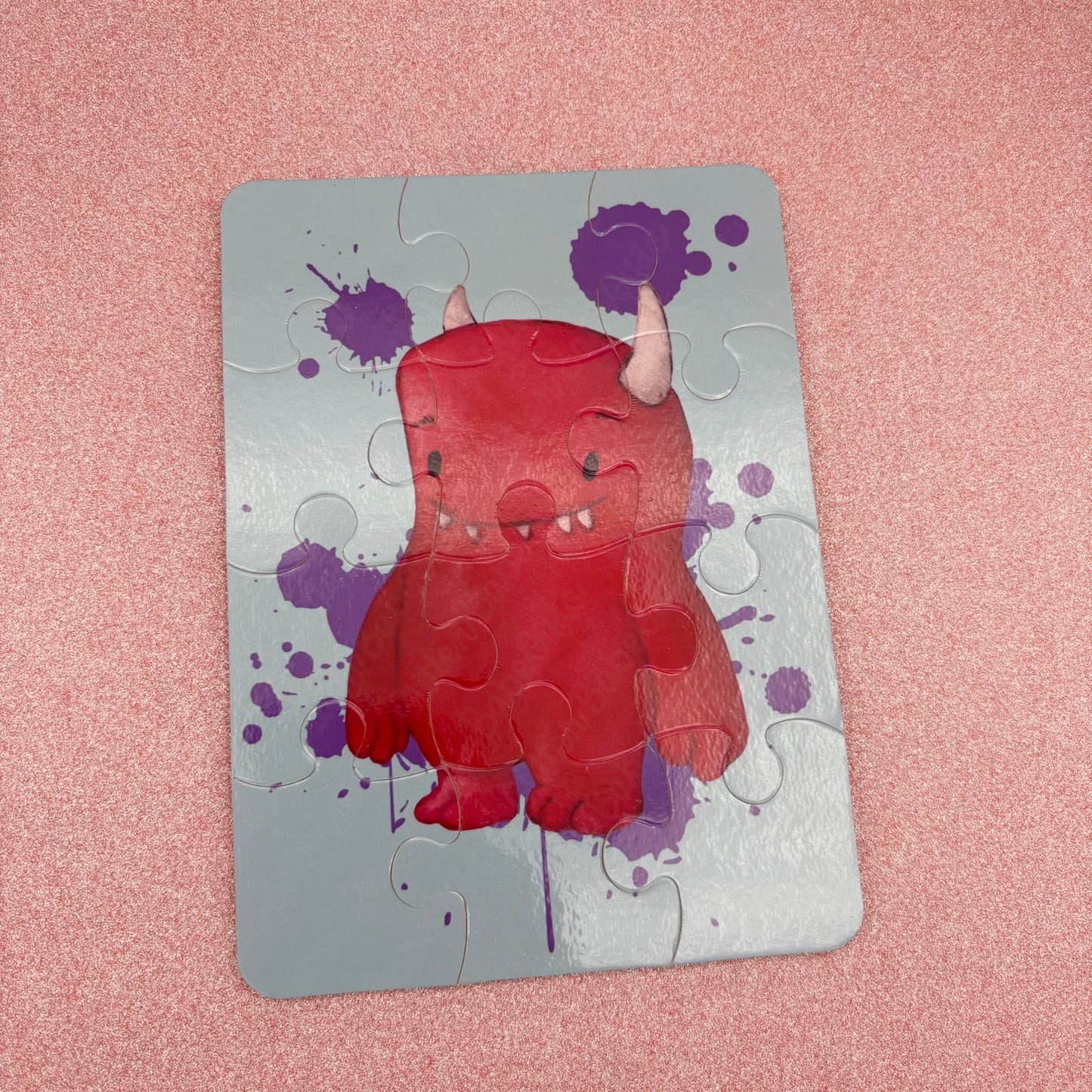 Jigsaw puzzle with a Pink monster design on a pink background