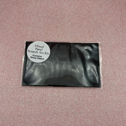 Black scratch art kit packaging on a pink textured background