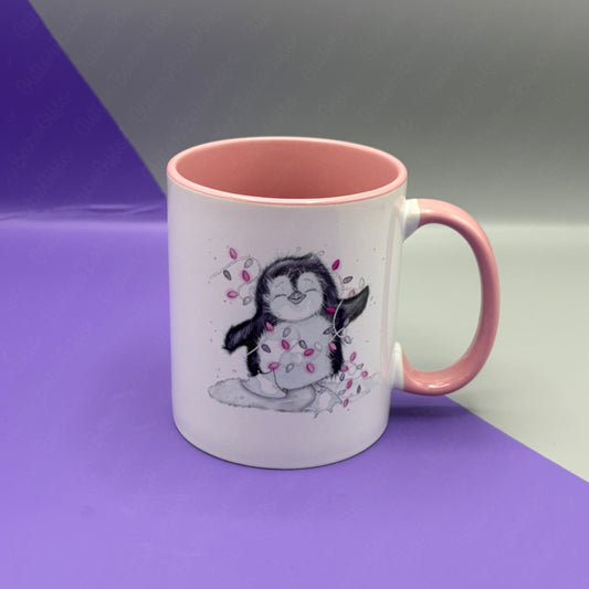 White mug with pink handle and interior, featuring a penguin design on a purple and gray background