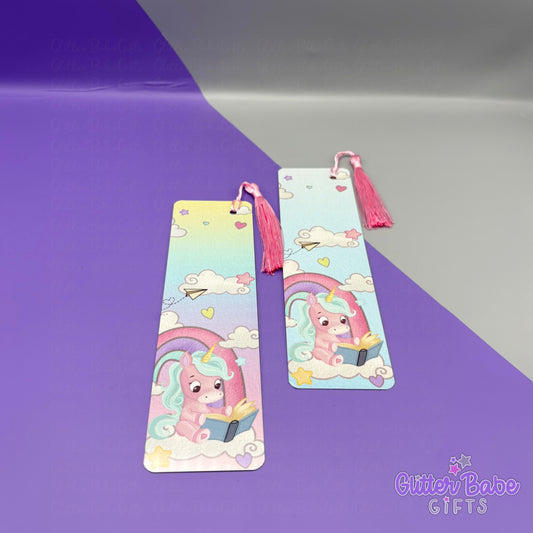 Two colourful bookmarks with cartoon unicorn designs on a purple and Grey background with Glitter Babe Gifts watermark.