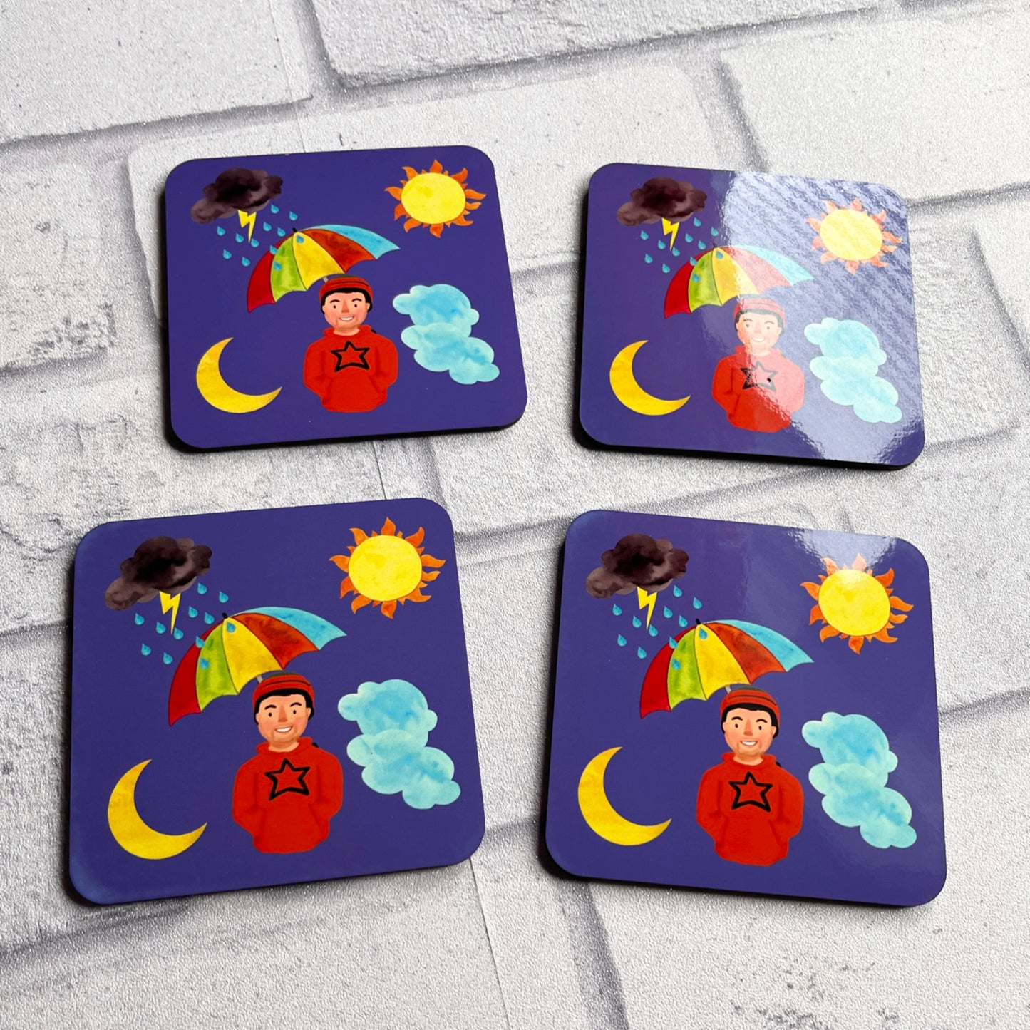 4 weather themed coasters on white background