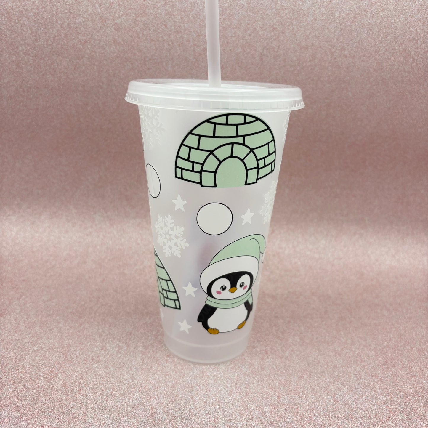 Clear tumbler with a mint coloured penguin design on a pink background