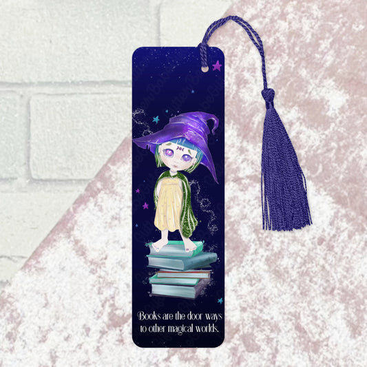 a witch design on a bookmark with wording "books are the door ways to other magical worlds" on it with a purple tassel. the bookmark lies on a purple and grey background