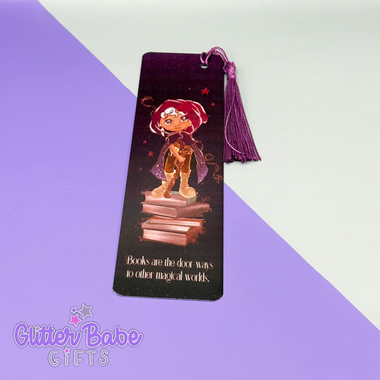a wizard deign on a bookmark with wording "books are the door ways to other magical worlds" on it with a purple tassel. the bookmark lies on a purple and grey background