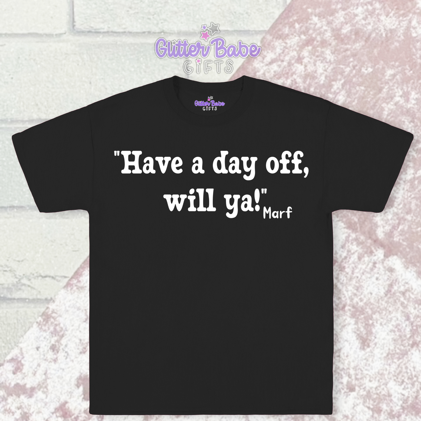 black t-shirt with white writing on a pink and white background